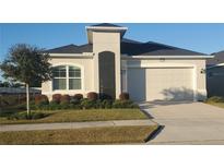 Charming single-story home with well-manicured lawn, neat landscaping, and a two-car garage at 2154 Wallingford Loop, Mount Dora, FL 32757