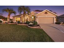 Attractive single-story home with landscaping and a two-car garage at 1427 Fortaleza Dr, The Villages, FL 32162