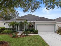 Single-story house with landscaped yard and two-car garage at 4351 Hammersmith Dr, Clermont, FL 34711