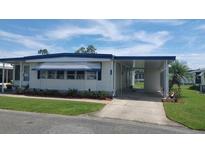 Charming single-story home with carport and manicured lawn, perfect for comfortable living at 117 Hibiscus Way, Leesburg, FL 34748