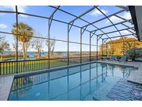 Inviting pool with screened enclosure offering lake views at 30303 Island Club Dr, Tavares, FL 32778