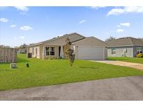 Newly constructed home with a front yard and driveway at Tbd S Central Ave # Parcel C, Apopka, FL 32703