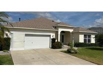 Charming one-story home with well-manicured lawn, attached two-car garage, and inviting front entrance at 1270 Addison Ave, The Villages, FL 32162
