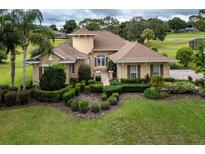 Gorgeous home featuring lush landscaping, manicured lawn, and a welcoming entrance at 39539 Harbor Hills Blvd, Lady Lake, FL 32159
