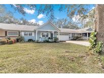 House exterior showing front yard landscaping and a partial view of neighboring homes at 8850 Sw 97Th St # E, Ocala, FL 34481