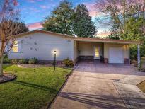 Inviting home with carport and landscaped yard at 1710 Hilton Head Blvd, The Villages, FL 32159