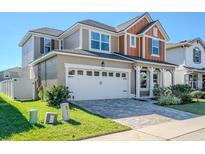 Two-story house with craftsman style accents and a landscaped front yard at 1827 Merrivale Loop, Ocoee, FL 34761