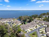 Waterfront townhomes boast serene lake views and well-manicured landscaping in a desirable lakeside community at 2247 Cypress Cove Dr # E2, Tavares, FL 32778
