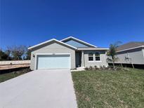Charming single-story home features a well-manicured lawn, a two-car garage, and excellent curb appeal at 2884 Supermarine Rd, Tavares, FL 32778