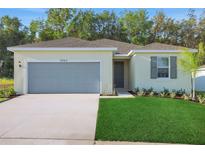 Charming one-story home boasts a two-car garage and well-manicured lawn, creating an inviting curb appeal at 2992 Supermarine Rd, Tavares, FL 32778