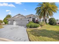 Beautiful one-story home with a two-car garage and lush landscaping at 3248 Killington Loop, The Villages, FL 32163