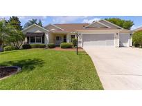 Attractive single-story home with a two-car garage and well-manicured lawn at 546 Foxfield Path, The Villages, FL 32162