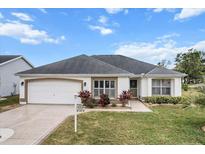 Attractive single-story home with a two-car garage and well-manicured lawn at 603 San Pedro Dr, Lady Lake, FL 32159