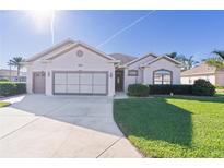 Charming one-story house with a two-car garage, and lush green lawn at 11038 Se 170Th Lane Rd, Summerfield, FL 34491