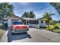 Ranch home with classic car in the driveway at 422 W 11Th Ave, Mount Dora, FL 32757