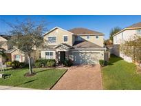 Two-story house with landscaping and brick driveway at 1741 Bonser Rd, Minneola, FL 34715