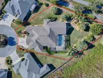 Aerial view of a luxurious home with a pool and landscaped yard at 1877 Quailey Ct, The Villages, FL 32163