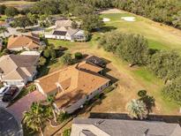 Expansive aerial view shows a meticulously maintained home near a golf course and mature landscaping at 17112 Se 71St Lewisfield Ter, The Villages, FL 32162