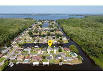 Aerial view of waterfront home with private dock and lush landscaping at 26637 Bermuda Dr, Tavares, FL 32778