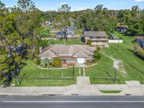 Aerial view of a single-Gathering home with a large yard and a second building on the property at 703 & 705 Cleveland Ave, Wildwood, FL 34785