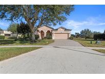 Single-story house with a two-car garage and well-maintained landscaping at 1070 Bentry Ct, Clermont, FL 34711