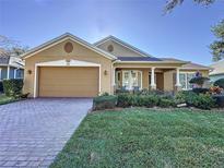 Beautiful one-story home with a large driveway and well-manicured lawn at 172 Crepe Myrtle Dr, Groveland, FL 34736