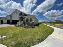 Charming single-Gathering home with a well-maintained lawn and a two-car garage at 2137 Sunshine Peak Dr, Minneola, FL 34715