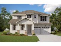 Two-story house with stone accents, gray doors, and a three-car garage at 2232 Juniper Berry Dr, Minneola, FL 34715