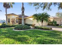 Single-story home with attractive landscaping and a paved driveway at 233 Monterey St, Kissimmee, FL 34759