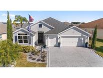 Two-story house with a large driveway and landscaped yard at 3259 Markward Dr, The Villages, FL 32163