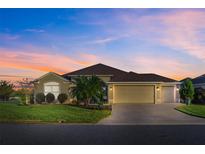 Beautiful one-story home with a two-car garage and well-manicured lawn at 3403 Rabbit Run Path, The Villages, FL 32163