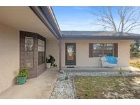 Tan house with brown roof, porch, and walkway at 11146 Pine St, Leesburg, FL 34788