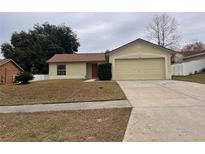 One-story house with attached garage and well-maintained lawn at 11550 Foxglove Dr, Clermont, FL 34711