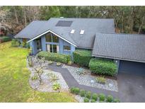 Aerial shot of a well-maintained house with a dark gray roof and neat landscaping at 1701 Cedar Stone Ct, Lake Mary, FL 32746