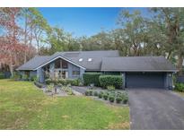 Charming home with a well-manicured lawn and lush landscaping at 1701 Cedar Stone Ct, Lake Mary, FL 32746
