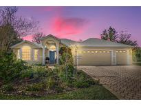 Attractive single-story home with landscaped yard and three-car garage at 1916 Antonia Pl, The Villages, FL 32159