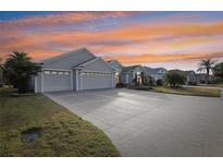 Luxury home with large driveway and surrounding community at 2054 Vision Ct, The Villages, FL 32163