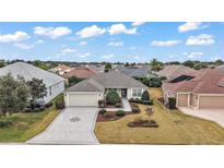 Single-story home with paved driveway and landscaped front yard at 2080 Nordic Ln, The Villages, FL 32163