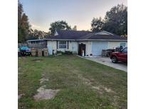 Ranch style home with attached garage and large yard at 2438 Centennial Blvd, Leesburg, FL 34748