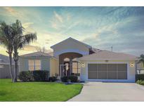 Beautiful one-story home with a two-car garage and lush landscaping at 27527 Briar Patch Pl, Leesburg, FL 34748