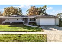 Updated single story home with a landscaped lawn and attached garage at 3336 Florene Dr, Orlando, FL 32806