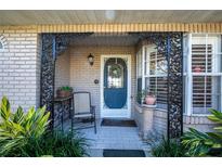 Detailed view of the front door entryway with ornate iron accents at 36703 Sandy Ln, Grand Island, FL 32735