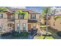 Two-story townhome with front porch and landscaping at 647 Calabria Ave, Davenport, FL 33897