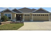 Attractive single-story home with two-car garage and landscaped lawn at 6851 Wendy Way, The Villages, FL 32163