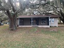 Cute ranch home with screened porch, located on a lakefront lot at 73 N Carol Ave, Mascotte, FL 34753