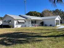 Charming single story home with a well-manicured lawn and covered porch at 10173 Se 175Th Ln, Summerfield, FL 34491