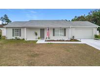 Newly built home with a landscaped front yard and attached garage at 11267 Sw 62Nd Avenue Rd, Ocala, FL 34476