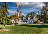 Charming single story home with a spacious lawn and white picket fence at 1735 Lakeshore Dr, Mount Dora, FL 32757