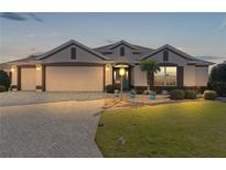 Attractive one-story home with a three-car garage and landscaped lawn at 1918 Yankee Clipper Run, The Villages, FL 32162