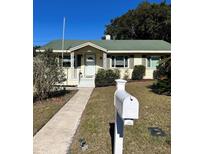 Charming single story home with green roof and landscaped yard at 505 W 10Th Ave, Mount Dora, FL 32757